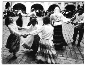 Young and old join in a lively dance in a courtyard of Vilnius University. 