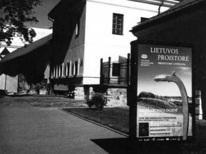 A poster in front of the museum invites passersby to visit the new Archaeology Exposition.