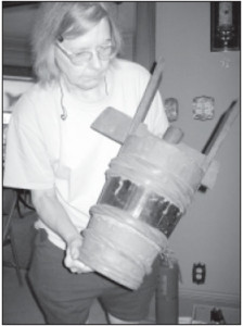 Mel’s wife Janet checks an old butter churn. 