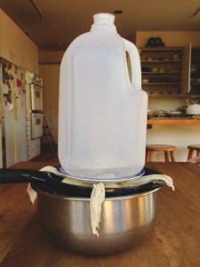 I used to make a “Leaning Tower of Paska” with pickle jars and soup cans. Now I use the stately gallon jug. Don't forget the plate under the jug—it distributes the weight evenly.
