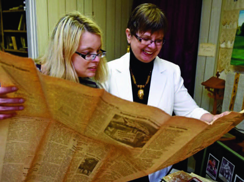 The author and her mother, Elaine, reading an archival copy of the Saulė newspaper.