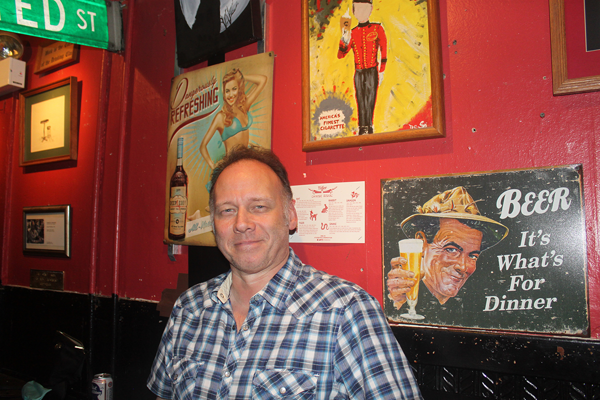 Owner Steve Badauskas at Bernice's Tavern with cool signs all over the walls.