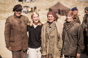 The author of Between Shades of Gray, Ruta Sepetys (second from left), on the set of her novel’s film adaptation Ashes in the Snow. “All of the extras and some of the principal actors – the elderly people – were actual survivors deported as children.”