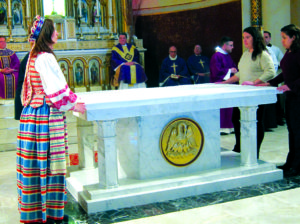 Monika Kungienė (left) with other parishioners cover the altar in a solemn ceremony.