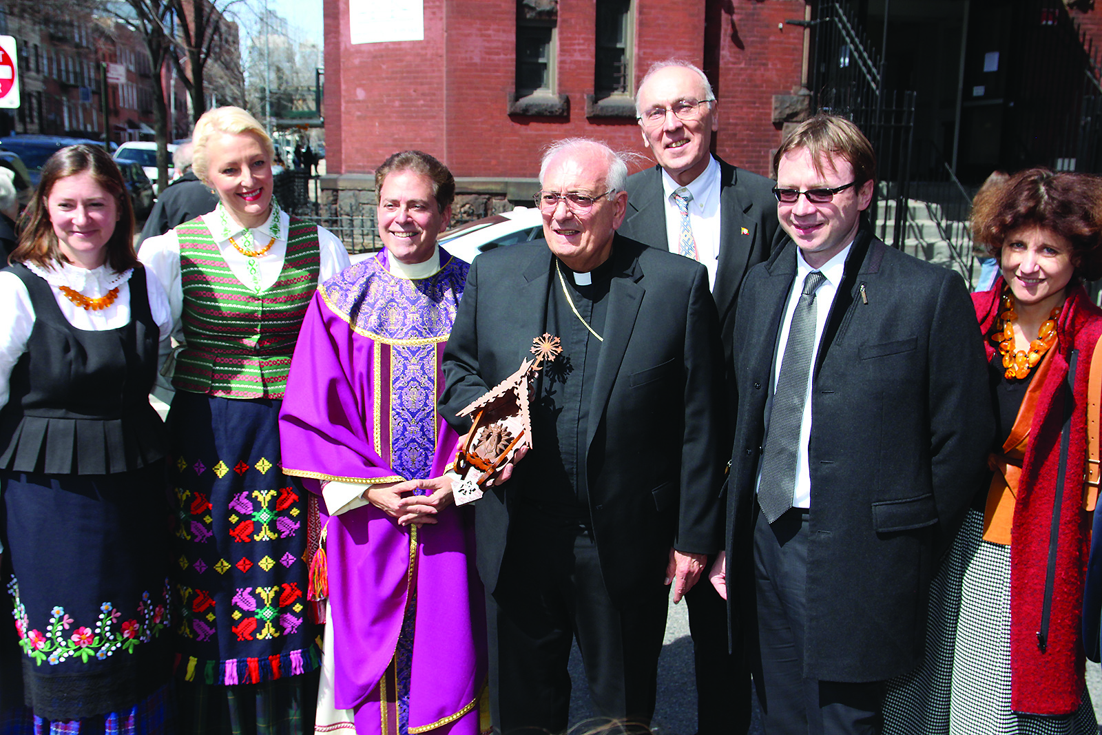 Lithuanians present a gift (Chapel of the Gates of Dawn) to Bishop Nicholas DiMarzio of Brooklyn. From left to right: Gitana Skripkaitė, Acting Chairman of the Consulate General of the Republic of Lithuania in New York; Rasa Sprindys, Chairman of the Lithuanian Community of New York; Msgr. Jamie Gigantiello, Pastor of Annunciation parish; Bishop Nicholas DiMarzio of Brooklyn; Raimundas Šližys;, Rolandas Kriščiūnas, the Ambassador of the Republic of Lithuania to the US; and Ambassador Audra Plepytė, Permanent Representative of Lithuania to the UN.