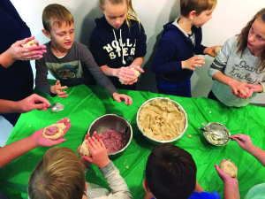 Vaikai turi progą išmokti gaminti lietuviškus cepelinus, kuriais patys noriai vaišinasi.